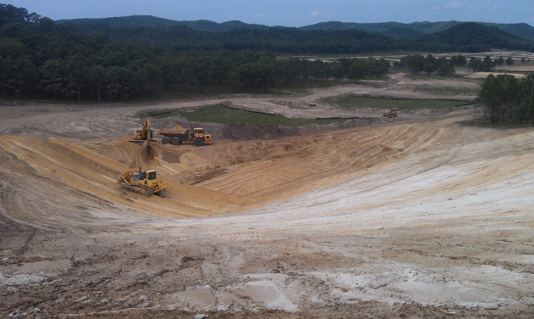 Heavy machinery operating in a large open-pit excavation site.