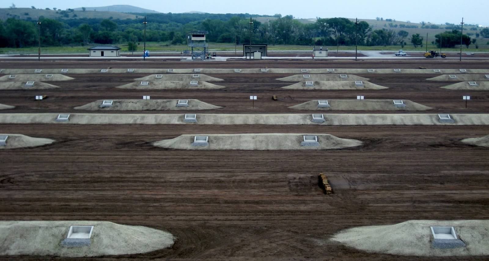 An aerial view of a large outdoor motocross track with starting gates and dirt trails.